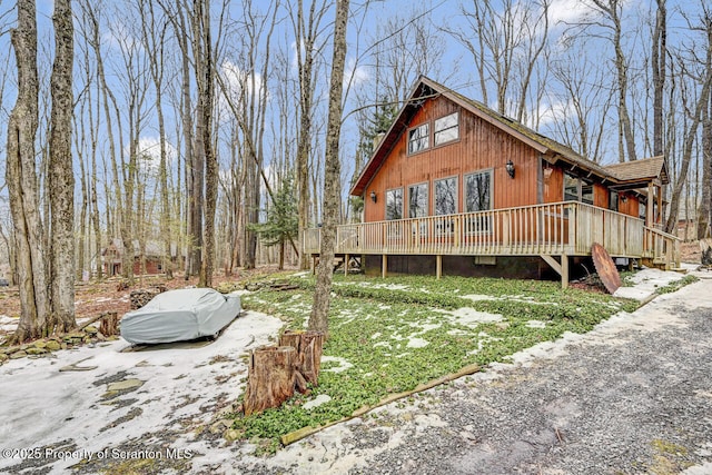 view of home's exterior with a wooden deck