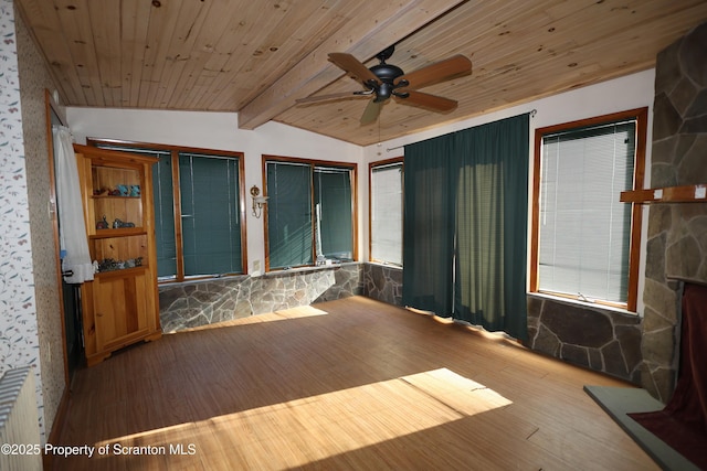 empty room featuring wooden ceiling, radiator heating unit, ceiling fan, and wood finished floors