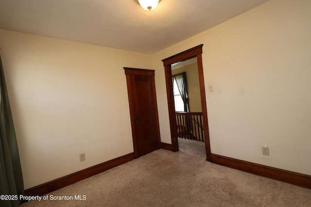 carpeted spare room with baseboards