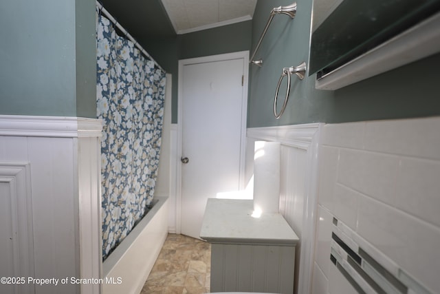 full bathroom with shower / tub combo and wainscoting