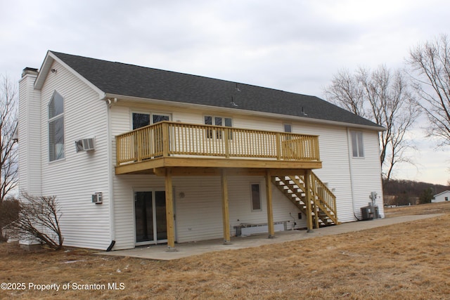 rear view of property featuring central AC, roof with shingles, a wooden deck, a chimney, and a patio area