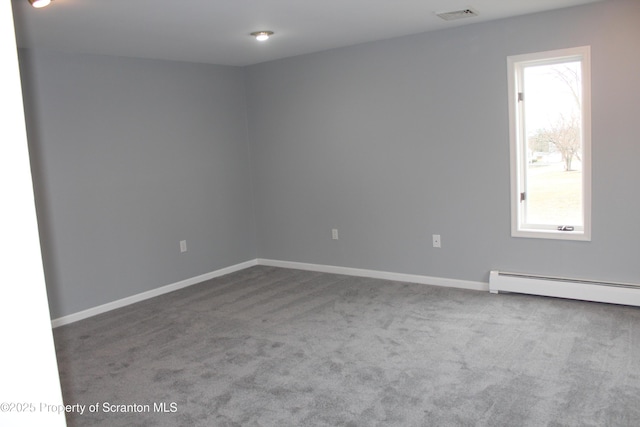 spare room featuring carpet, baseboards, visible vents, and a baseboard radiator