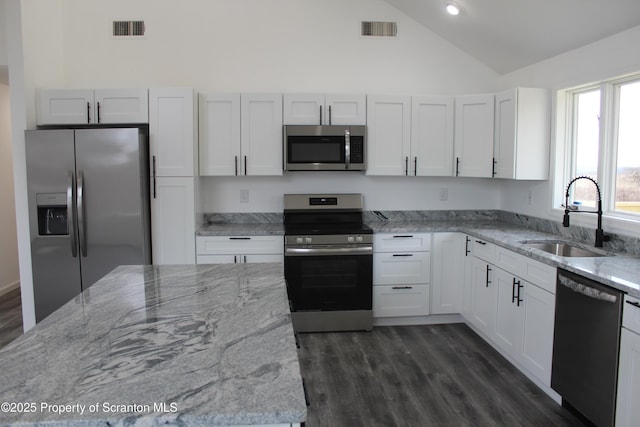 kitchen with a sink, visible vents, dark wood-type flooring, and appliances with stainless steel finishes