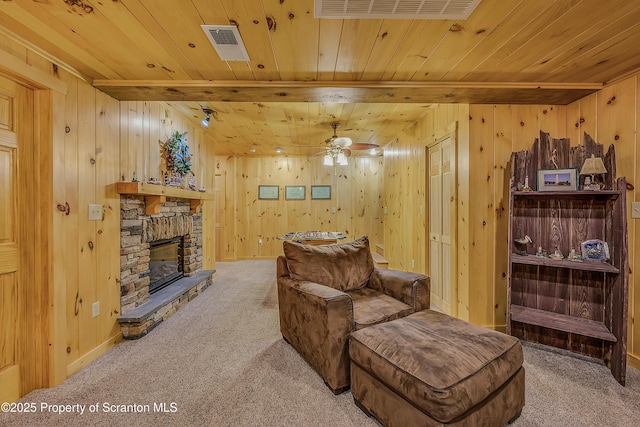 5 Capricorn Cir, Lake Ariel, PA 18436 - living area with light colored carpet, wooden ceiling, wooden walls, ceiling fan, and a fireplace
