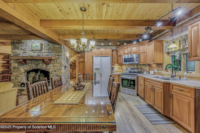 5 Capricorn Cir, Lake Ariel, PA 18436 - kitchen featuring light wood-style floors, appliances with stainless steel finishes, light countertops, decorative light fixtures, and a wooden ceiling with exposed beams