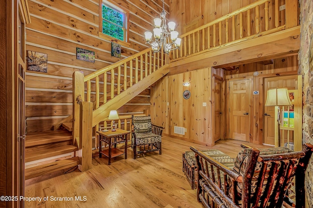 5 Capricorn Cir, Lake Ariel, PA 18436 - stairs with wood walls, a chandelier, a high ceiling, and wood finished floors