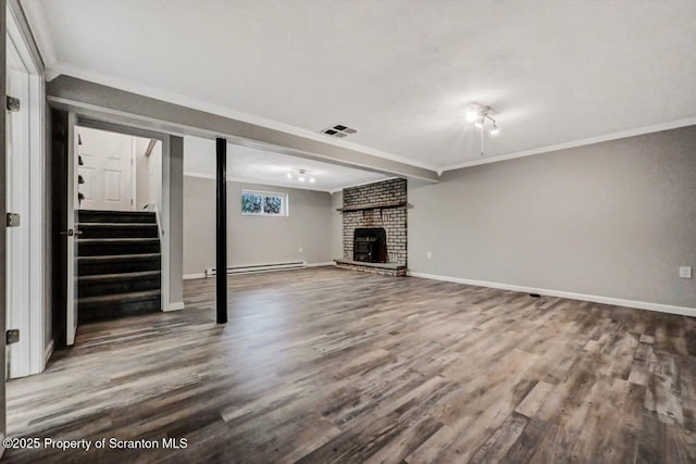 basement with baseboard heating, wood-type flooring, and ornamental molding