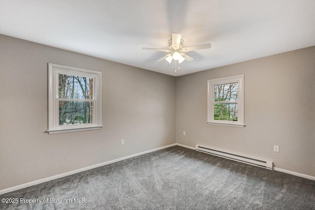 unfurnished room with carpet flooring, ceiling fan, a wealth of natural light, and a baseboard heating unit