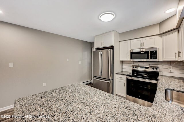 kitchen featuring light stone countertops, white cabinets, and appliances with stainless steel finishes