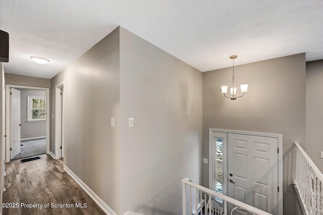 foyer with a chandelier and hardwood / wood-style floors