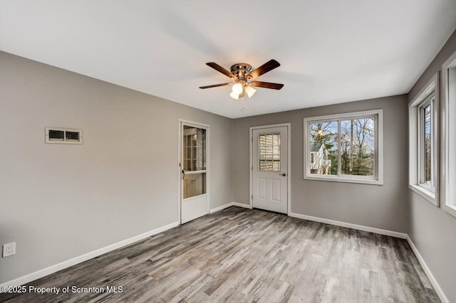 empty room with light wood-type flooring and ceiling fan