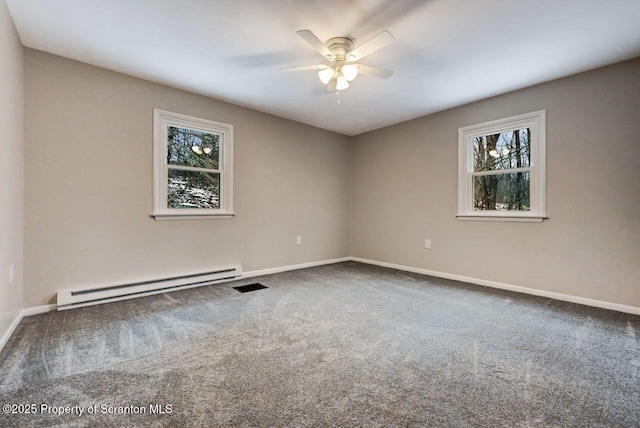 carpeted spare room featuring a baseboard radiator, a wealth of natural light, and ceiling fan