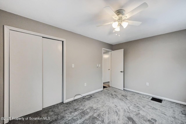 unfurnished bedroom featuring carpet flooring, ceiling fan, and a closet