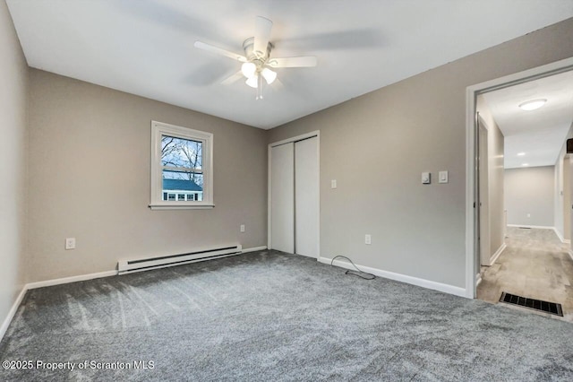 unfurnished bedroom featuring carpet flooring, a closet, ceiling fan, and a baseboard heating unit