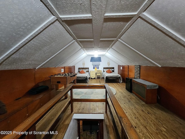 bonus room featuring lofted ceiling and hardwood / wood-style flooring