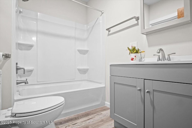 full bath with vanity, toilet, shower / washtub combination, and wood finished floors