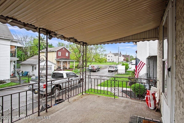 view of patio / terrace featuring a porch and a residential view