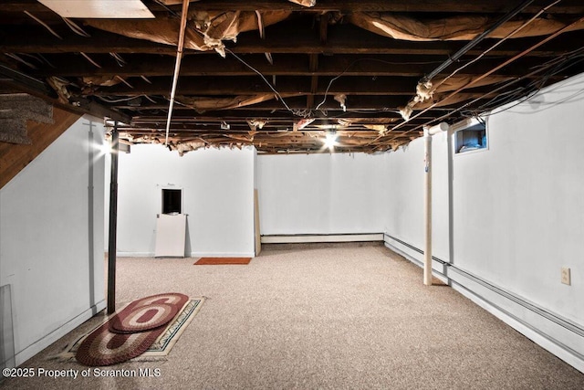unfinished basement featuring baseboard heating and carpet floors