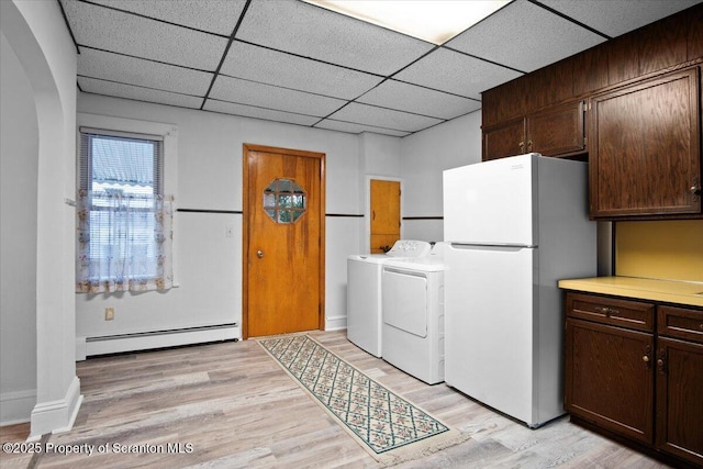 laundry area with independent washer and dryer, light wood-type flooring, baseboards, and baseboard heating