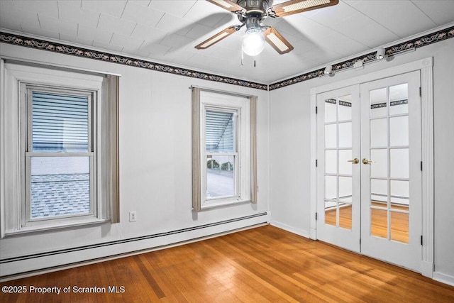unfurnished room with baseboard heating, french doors, ceiling fan, and wood finished floors
