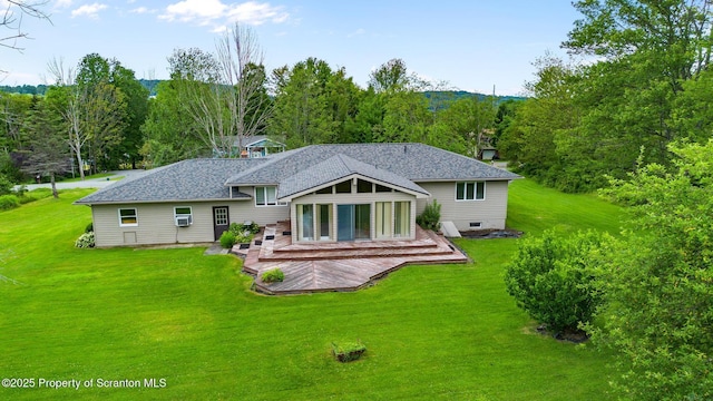 32 Christy Ln, Scott Twp, PA 18447 - rear view of property with a deck, a yard, a shingled roof, and a forest view
