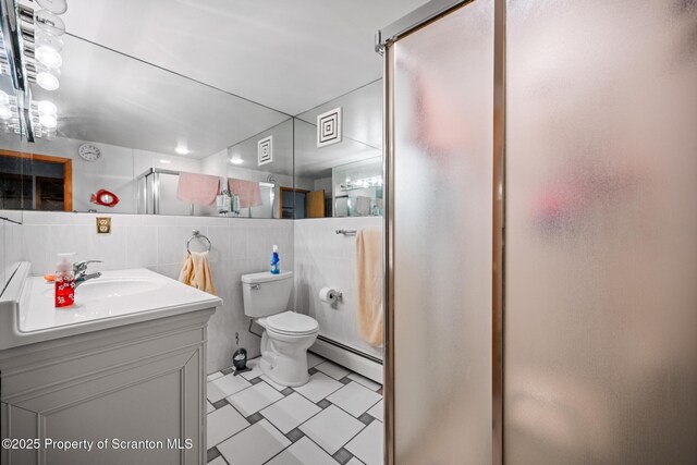 32 Christy Ln, Scott Twp, PA 18447 - full bathroom featuring baseboard heating, a stall shower, vanity, and tile walls