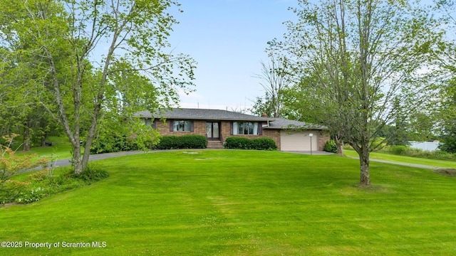 32 Christy Ln, Scott Twp, PA 18447 - view of front facade with a garage, a front yard, driveway, and brick siding