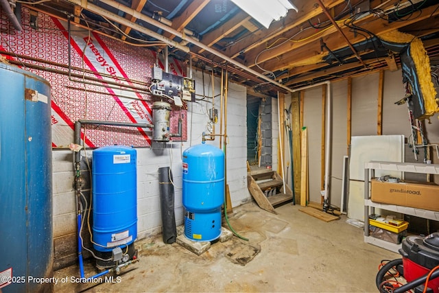 32 Christy Ln, Scott Twp, PA 18447 - unfinished basement featuring a water pressure tank and freestanding refrigerator