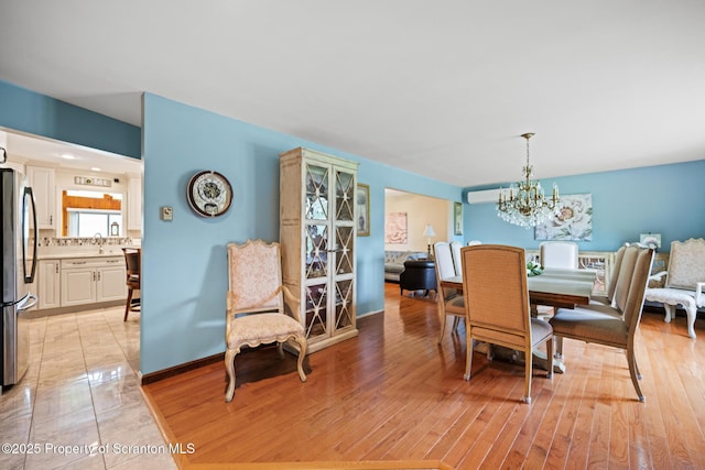 32 Christy Ln, Scott Twp, PA 18447 - dining room with a chandelier, light wood-style floors, and a wall unit AC
