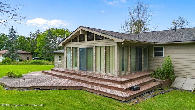 32 Christy Ln, Scott Twp, PA 18447 - rear view of property featuring a wooden deck, a lawn, and roof with shingles