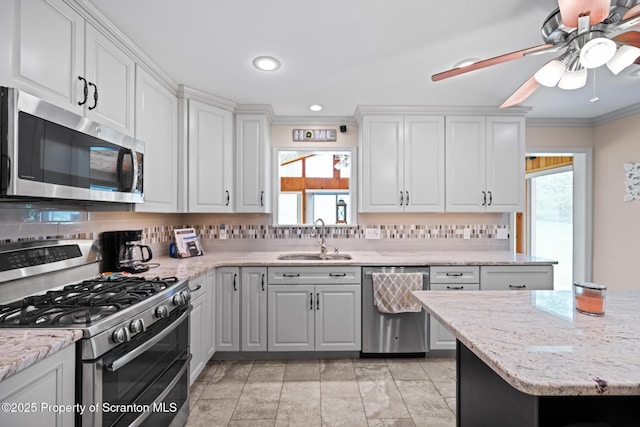 32 Christy Ln, Scott Twp, PA 18447 - kitchen with stainless steel appliances, crown molding, backsplash, ceiling fan, and white cabinetry