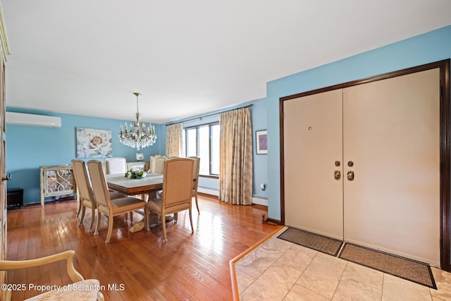 32 Christy Ln, Scott Twp, PA 18447 - dining room featuring hardwood / wood-style floors, a baseboard heating unit, a chandelier, and a wall unit AC