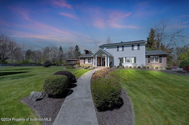 view of front of property with a yard