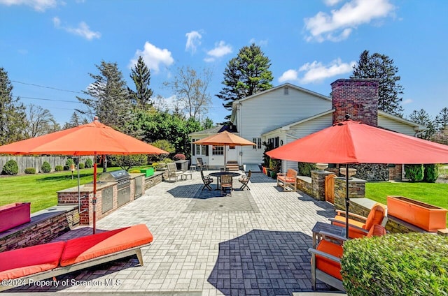 view of patio / terrace with an outdoor kitchen and a grill