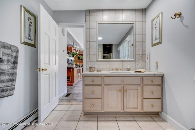 bathroom featuring vanity, a baseboard radiator, tile patterned floors, and backsplash