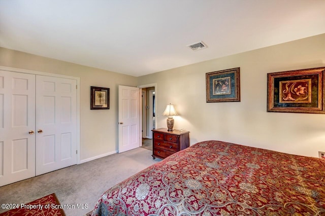 bedroom with light carpet and a closet