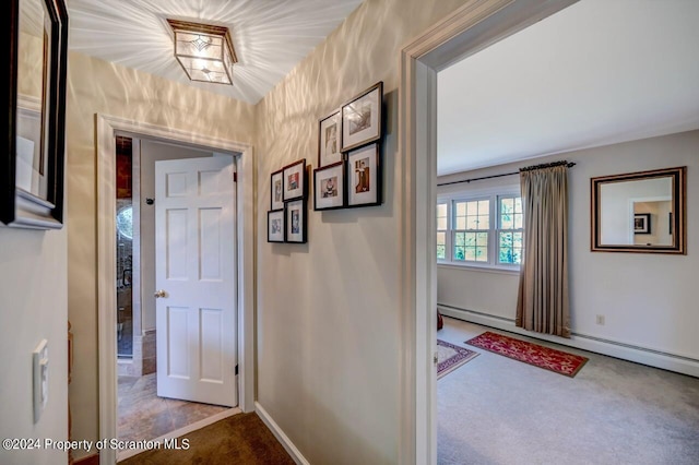 corridor featuring carpet floors and a baseboard radiator