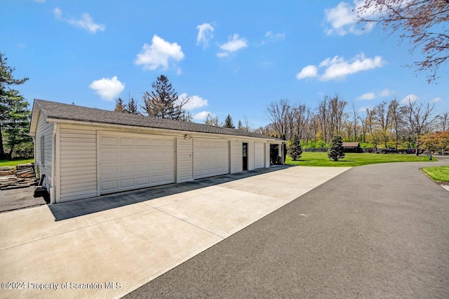 garage featuring a yard