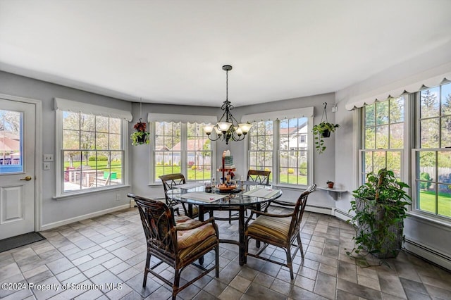 dining area with a notable chandelier and a baseboard heating unit