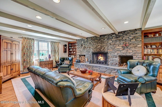 living room featuring beam ceiling, a fireplace, and light hardwood / wood-style flooring