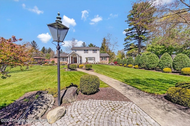 rear view of property with a lawn