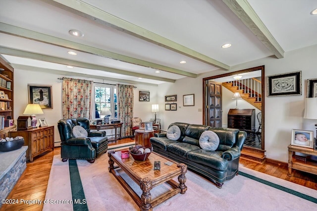 living room featuring beam ceiling and light wood-type flooring