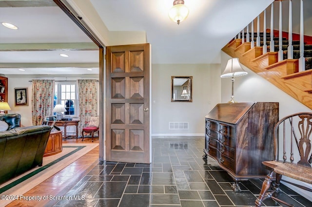 foyer entrance with beam ceiling