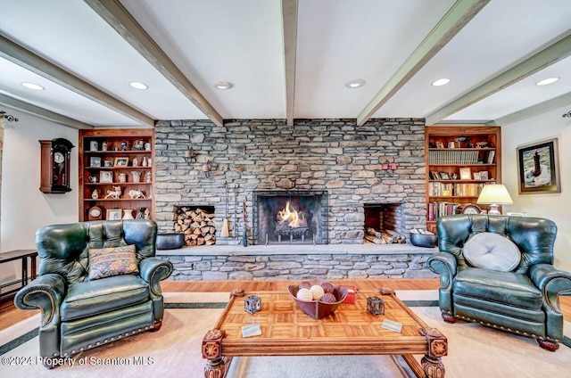 living room featuring a stone fireplace, built in features, and beamed ceiling