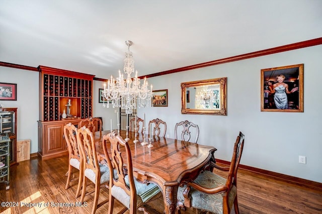 dining room featuring crown molding, dark wood-type flooring, and an inviting chandelier