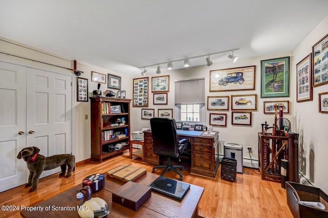 office space featuring light hardwood / wood-style floors and a baseboard radiator