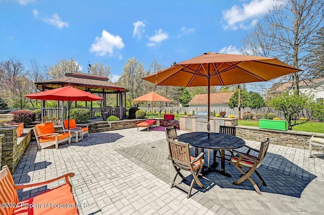 view of patio featuring a gazebo, an outdoor kitchen, and grilling area