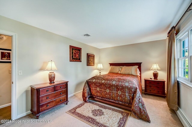 bedroom featuring a baseboard radiator and light colored carpet