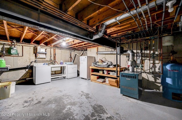 basement featuring sink, fridge, and independent washer and dryer