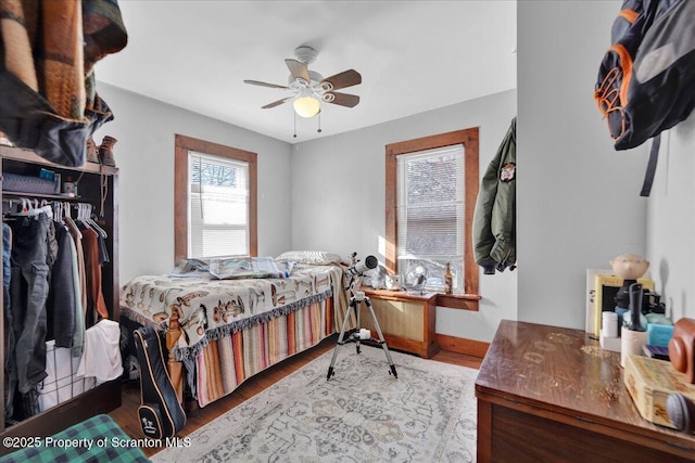 bedroom with hardwood / wood-style flooring, a closet, and ceiling fan